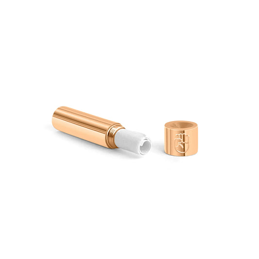 Rose gold plated stainless steel screw-top message capsule with an engraved raised fist symbol, shown open with a rolled handwritten note inside, designed for storing personal messages. Displayed on a clean white background.
