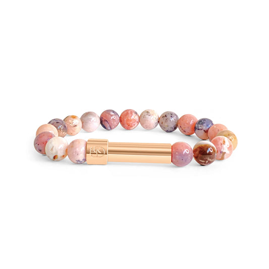 Pink Rhodonite beaded bracelet with a sleek stainless steel plated rose gold screw-top message capsule, designed to store handwritten notes, displayed on a white background