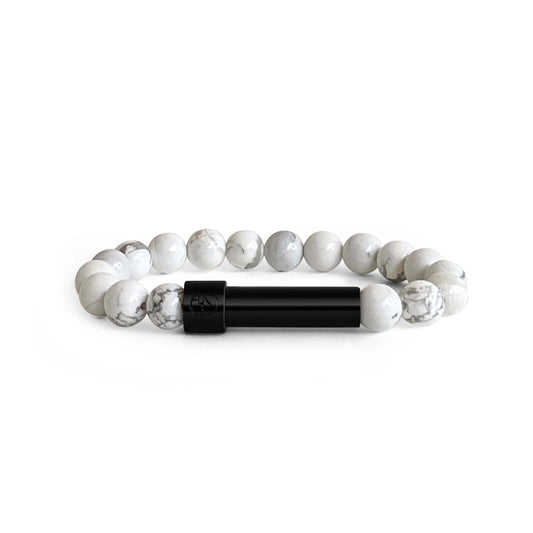 White Howlite beaded bracelet with a sleek black screw-top message capsule, designed to store handwritten notes, displayed on a white background.